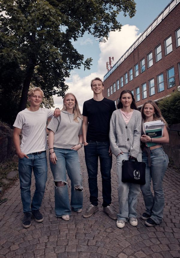 Elever är ute och går utanför skolan.